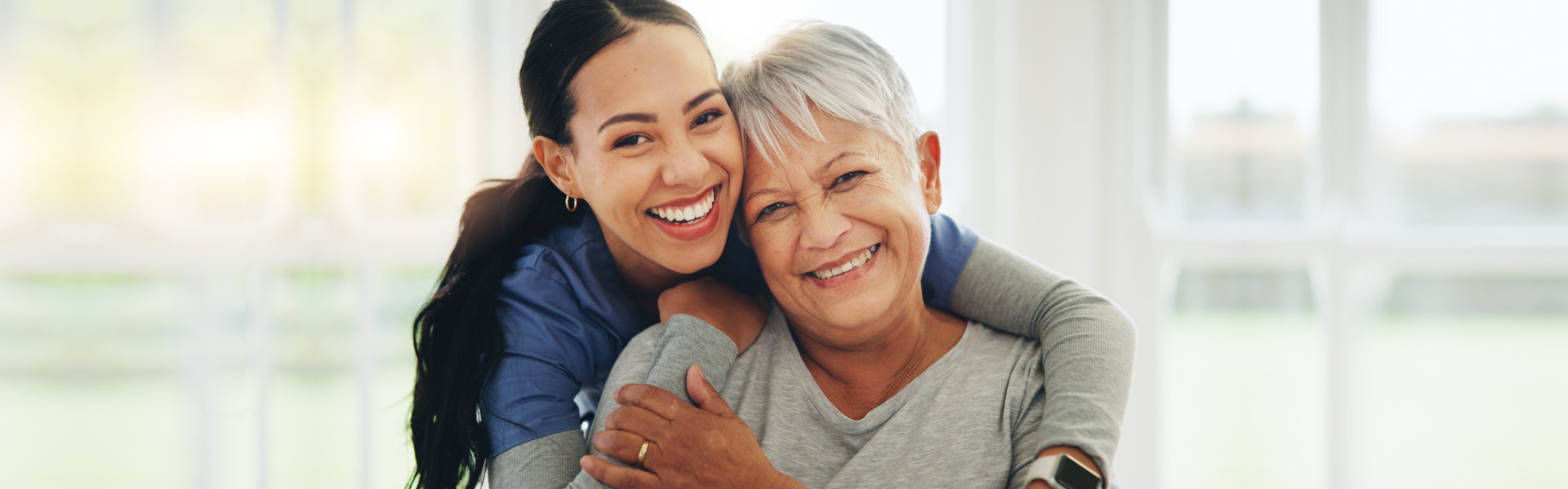 Caregiver and hug elderly woman