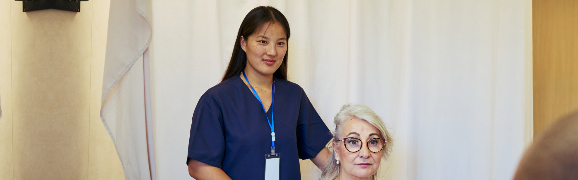 caregiver assisting an elderly
